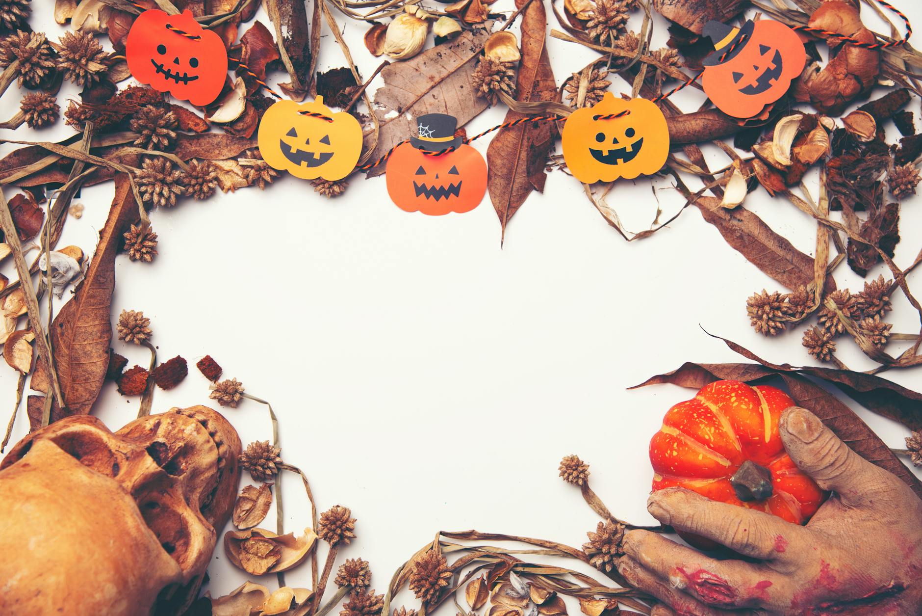 pumpkin and skull on table