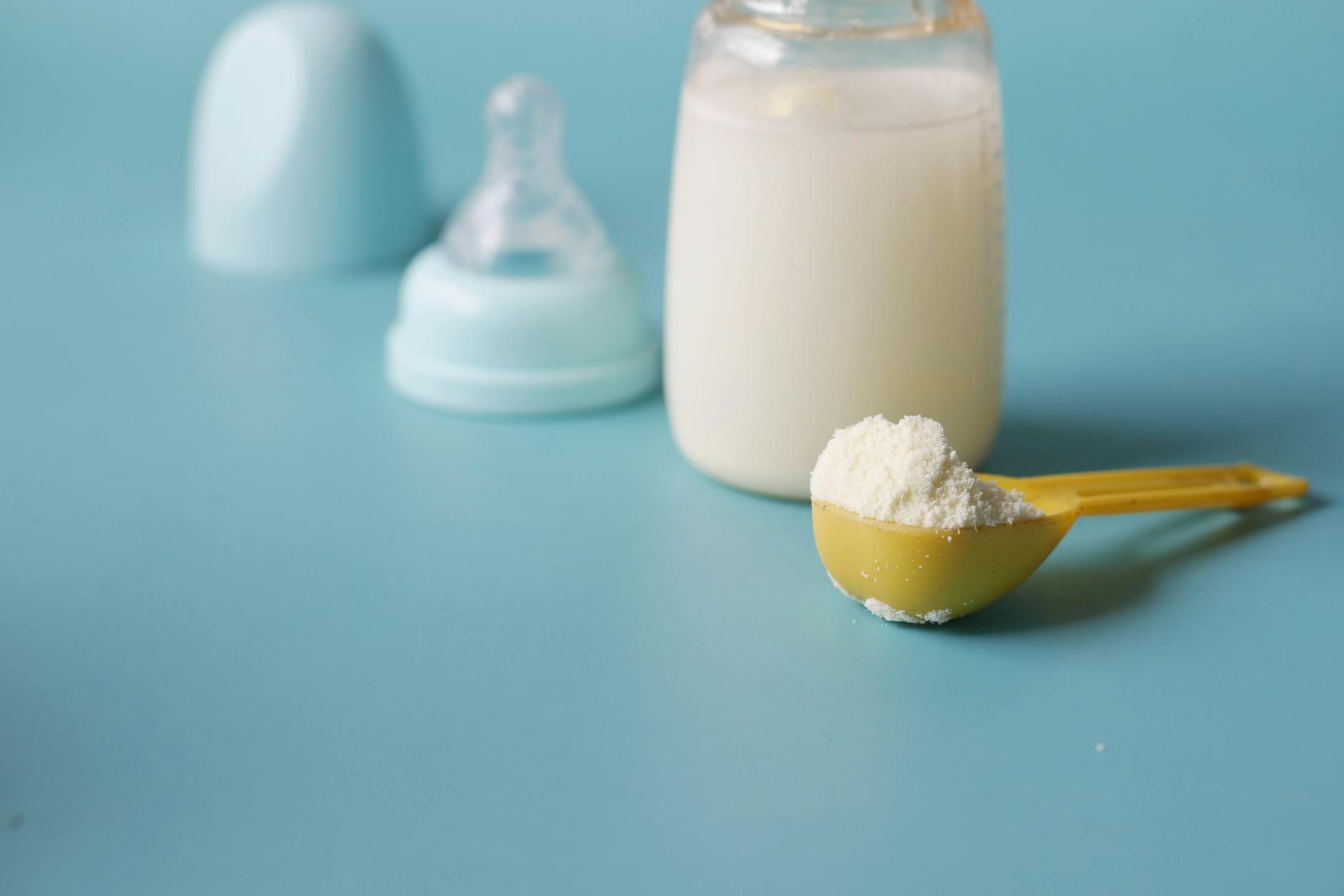 a close up shot of a scooped formula milk powder