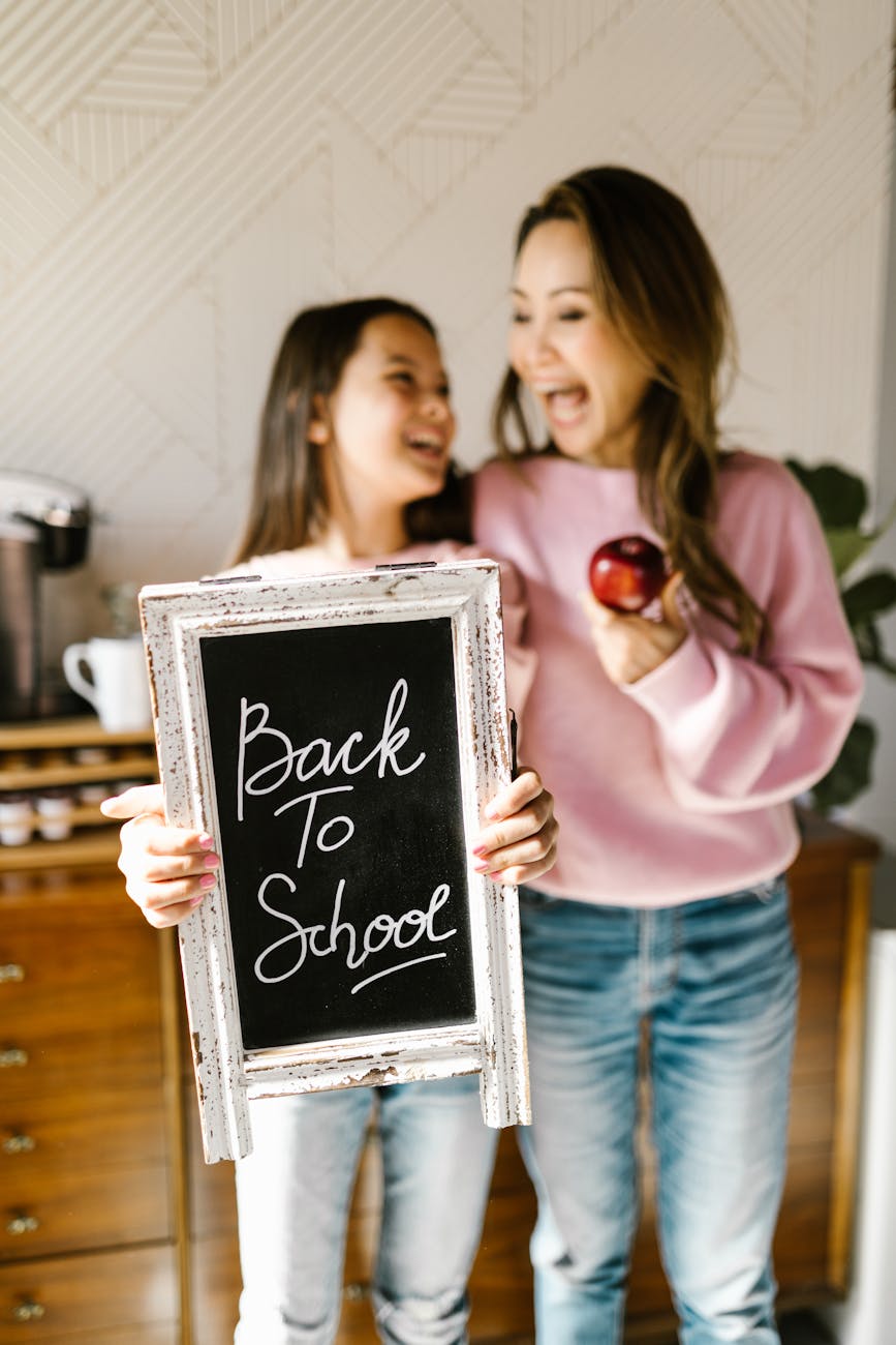 a girl holding a back to school signage