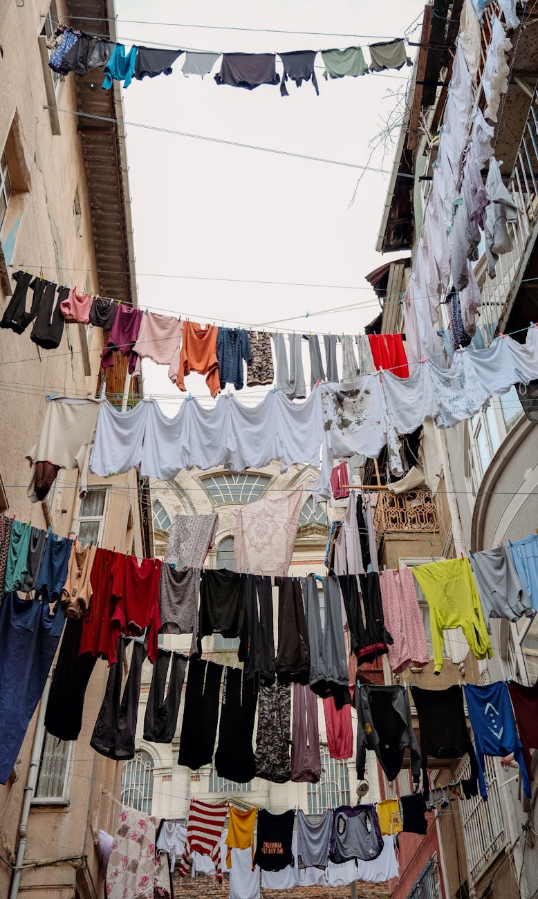 clothes hanging on clotheslines in a narrow alley