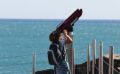 photo of kid using coin operated telescope