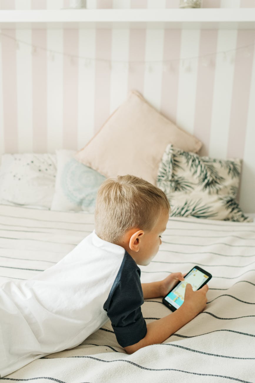 a boy playing a game on a smartphone