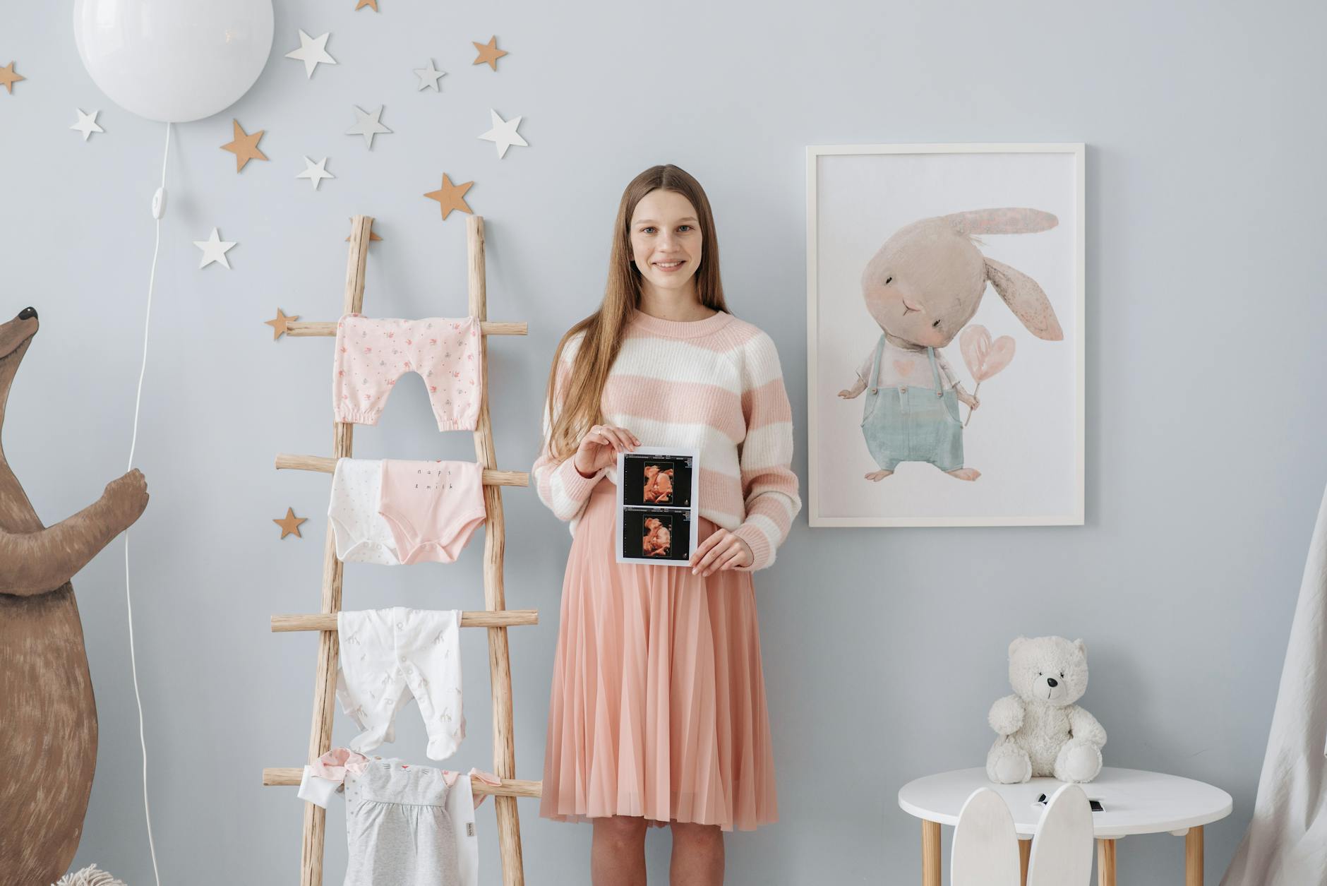 a pregnant woman holding her ultrasound result